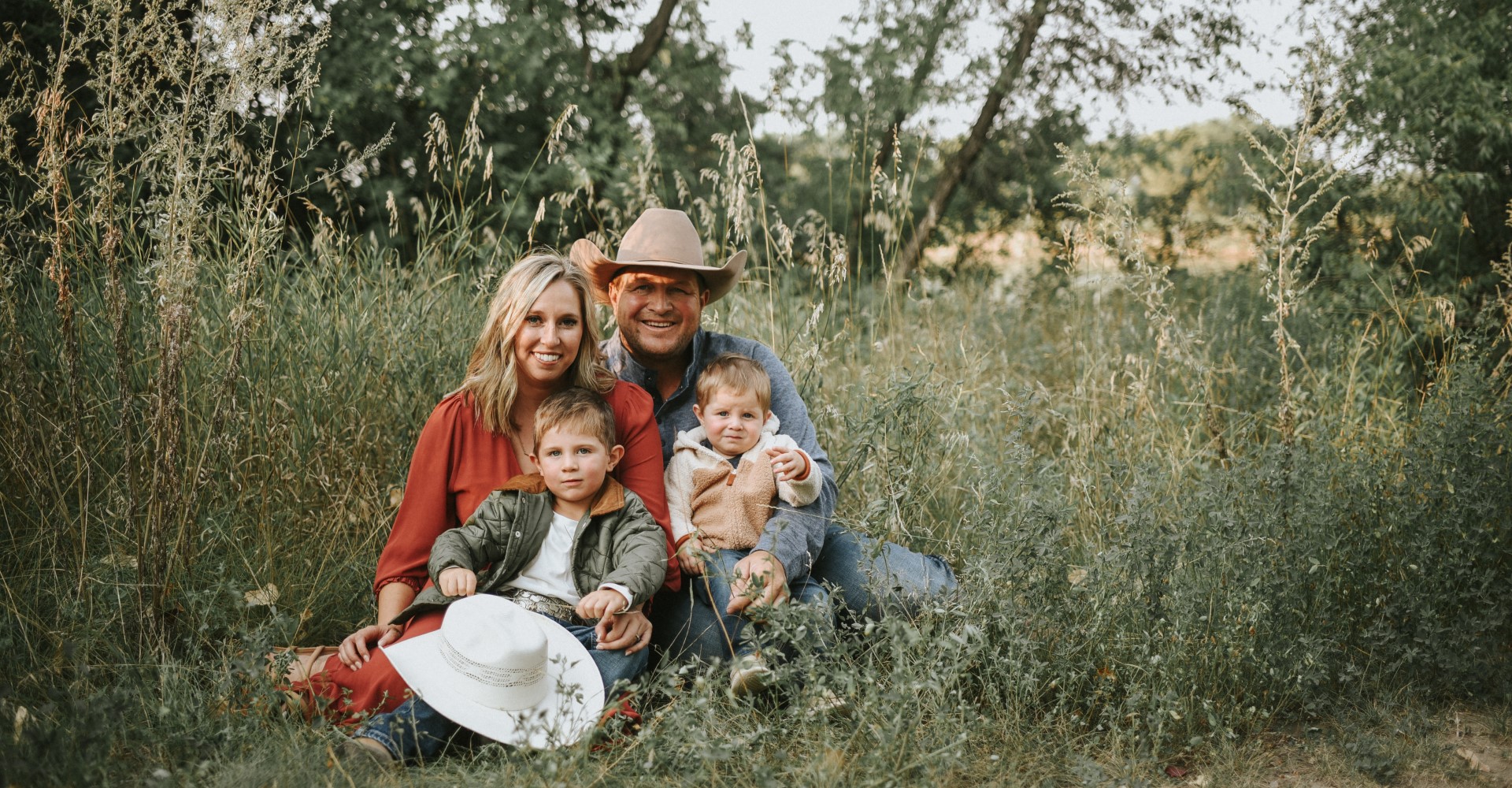 Bauman Family sitting in a field